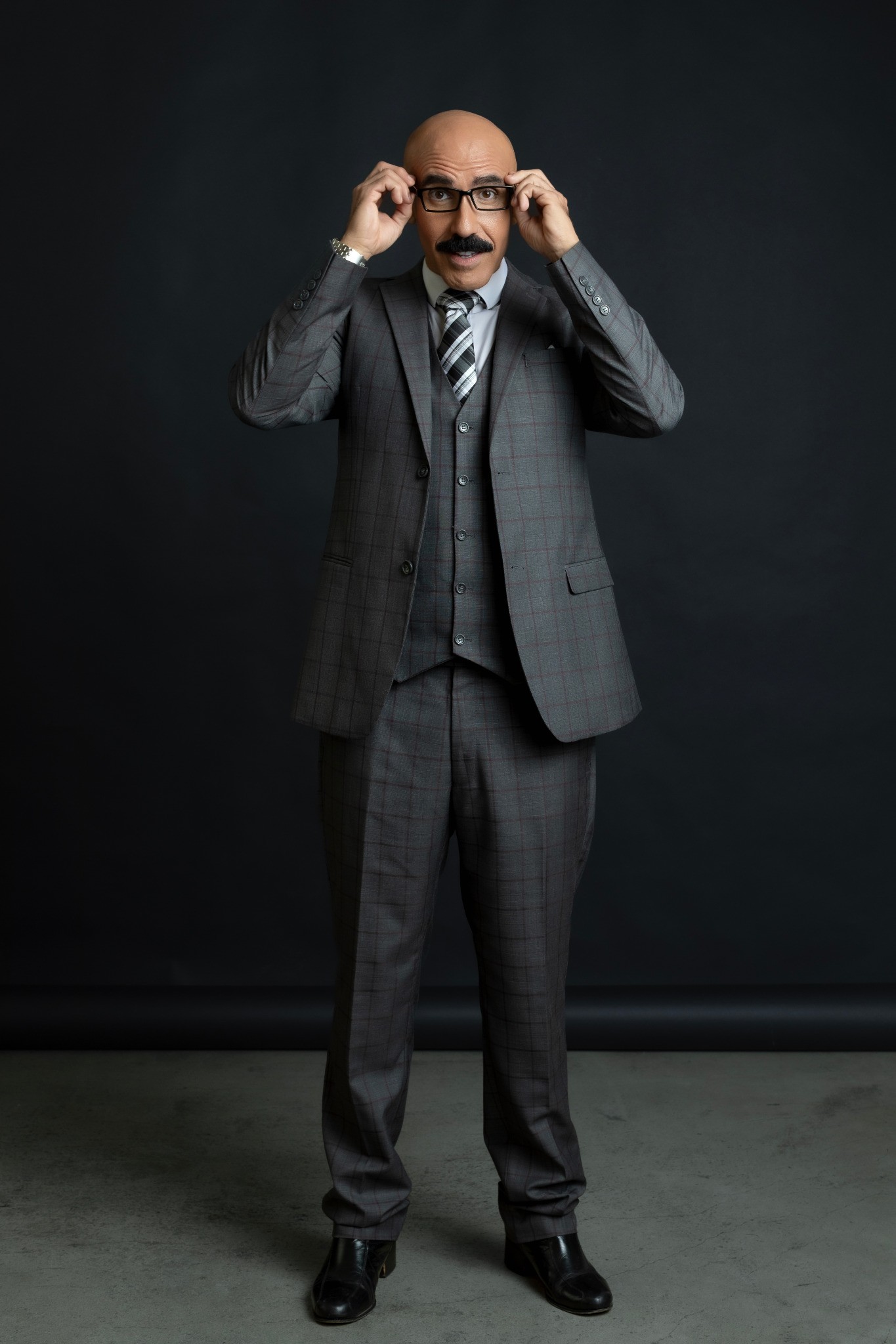 Gabriel Pablo Axarlian in a full-length tailored gray suit